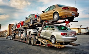 Bunch of Cars being delivered On An Outdoor Transport Carrier